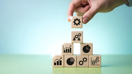 Hand stacking wooden blocks with business icons, symbolizing strategic process development, analysis, and growth for success