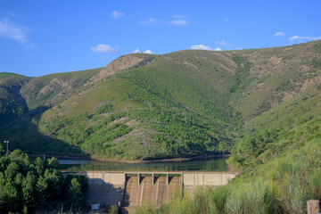 Las Monjas dam in green mountain landscape