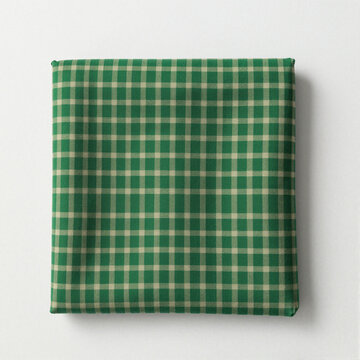 Green checkered Burmese longyi fabric folded into a neat square on a white background