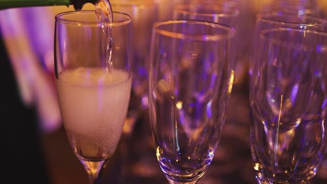 Alcohol setting on catering banquet table, bartender pouring liquor beverages, row line of different colored alcohol drinks on party, glass of wine, sparkling wine on decorated banquet table event