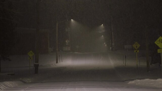 Heavy snow falling on an empty street in a small American town
