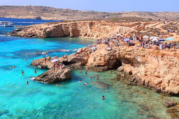 Naklejka premium Blue Lagoon is a natural pool with crystal clear waters. Malta's No 1 attraction: located in Comino island between the islands of Malta and Gozo.