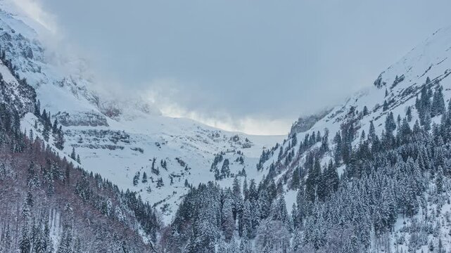 Time lapse, snowy mountain landscape in the Swiss Alps, clouds over mountain peaks. Canton of St. Gallen, Switzerland