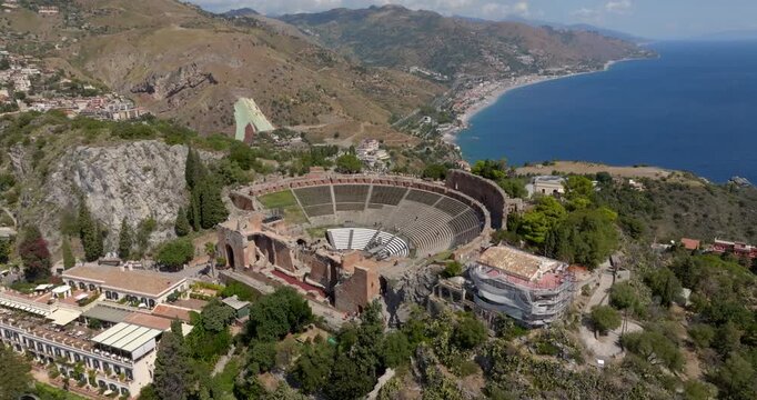 Aerial view of the theater of Taormina, in the province of Messina, Sicily, Italy. These are the ruins of an ancient Hellenistic theater from Greek period. The Mediterranean Sea is in the background.