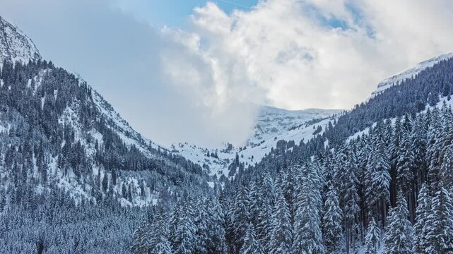 Time lapse, snowy mountain landscape in the Swiss Alps, clouds over mountain peaks. Canton of St. Gallen, Switzerland