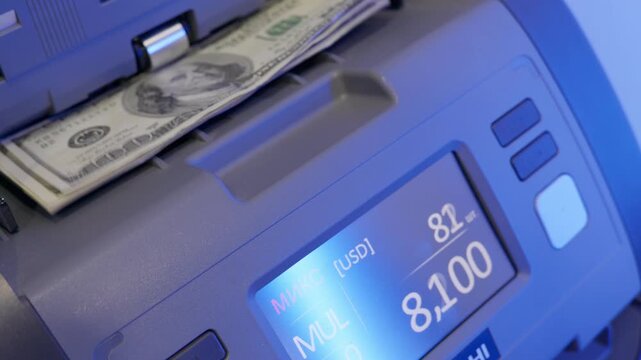 Abstract fast cash counting machine in action with blue light