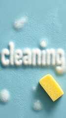 The word "cleaning" written in thick soap foam and a yellow sponge on a blue background. Banner with copy space. Cleaning service and premises maintenance concept vertical photo.
