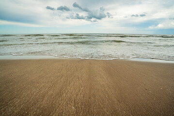 A beach with a large body of water in the background