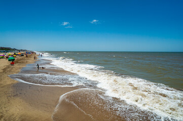 A beach with a lot of people and a lot of water