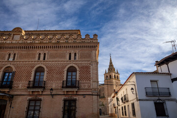 Obraz premium Facade of the Enriqueta villa in Villanueva de la Jara, Cuenca, Spain, with the Basilica of Our Lady of the Assumption in the background