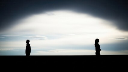 Isolated silhouetted man and woman, depicted in a powerful high-contrast conceptual photography style, standing far apart and facing away from each other across a stark horizon line, dramatically lit