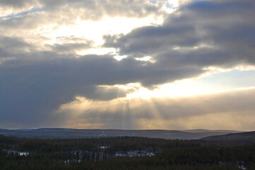 A mountain tundra landscape in Lapland in late spring, with snow still on the ground.