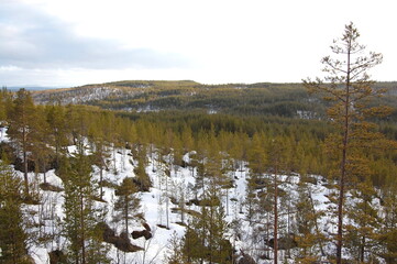 A mountain tundra landscape in Lapland in late spring, with snow still on the ground.