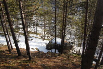 A mountain tundra landscape in Lapland in late spring, with snow still on the ground.