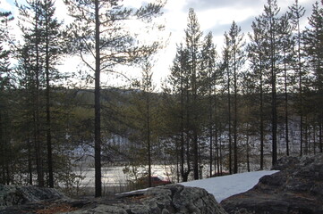 A mountain tundra landscape in Lapland in late spring, with snow still on the ground.
