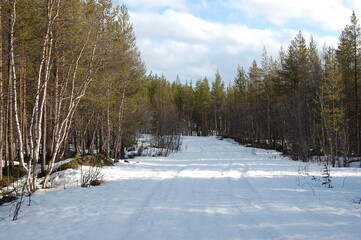 A mountain tundra landscape in Lapland in late spring, with snow still on the ground.