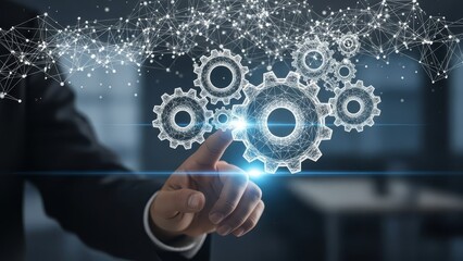 Finger touches a digital interface displaying a cluster of interconnected gears, surrounded by a network of light particles.