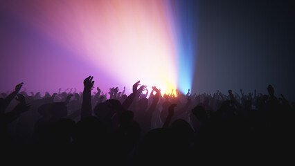 Enthusiastic crowd enjoying a music concert with arms raised in the air