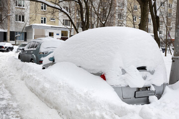 Heavy snowfall. The blizzard has covered the roads. Cars are stuck in snowdrifts.