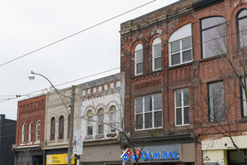Obraz premium historic building facades on Dundas St W, incl sign of Domino's Pizza at 1671 Dundas W, Toronto