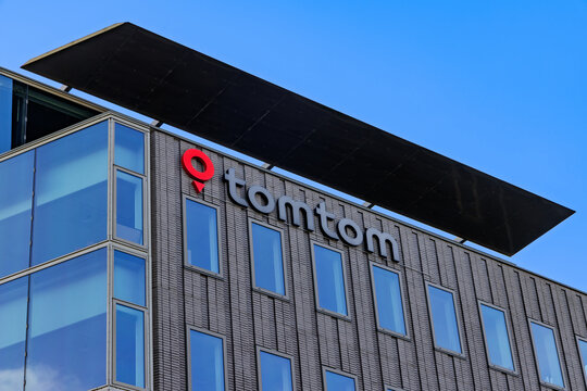 Exterior facade of the modern office building featuring the logo of navigation technology company TomTom against a blue sky. Amsterdam Netherlands, 28 december 2025