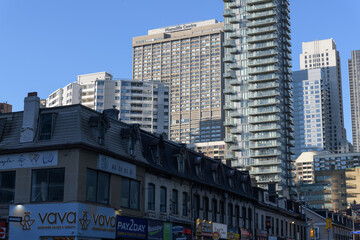 Naklejka premium looking northwest on Yonge St from St Joseph St to Manulife Centre, mixed-use complex at 55 Bloor St W, Toronto