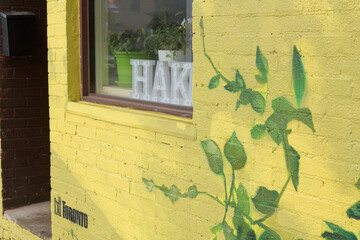 Naklejka premium mural on exterior wall of Hako · Noodle Bar, a Japanese noodle bar and café located at 870 Dundas St W in Toronto (minimalist, gallery‑like café serving espresso, tea, breakfast sandwiches)