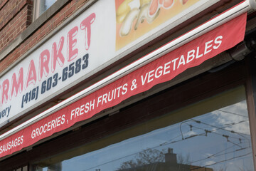 Naklejka premium close-up detail of sign outside Dundas Street Supermarket once located at 878 Dundas St W, Toronto