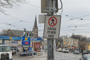 Naklejka premium looking east on Dundas St W from College St road sign and defocused Ultramar - Gas Station, Toronto