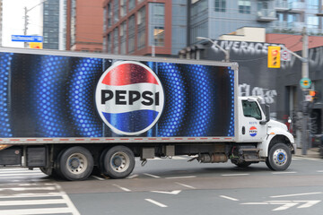 Naklejka premium Pepsi delivery truck heading west on Richmond St W at intersection of John St with motion blur, Toronto