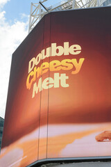 Obraz premium digital billboard featuring Double Cheesy Melt, a limited‑time burger item on the McDonald’s Canada menu in 2026 at Sankofa Square, Toronto