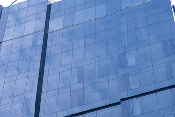 Blue windows of modern office skyscraper closeup