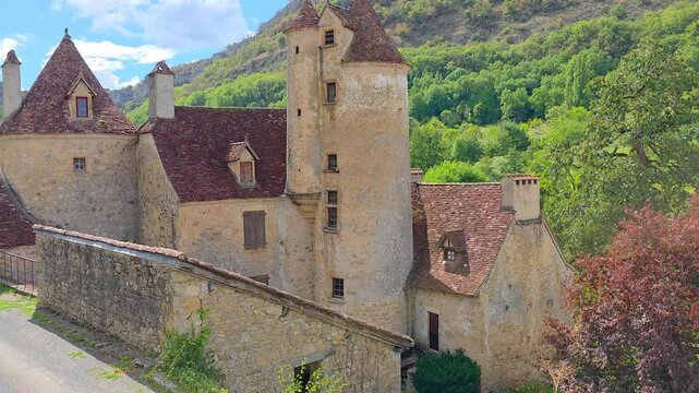 Beautiful turreted medieval building in the valleys of the Lot region of France. Handheld panning motion.