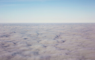 Soft abstract sky background with endless cloud layer under clear blue horizon, minimal atmospheric texture for calm design, meditation, travel concepts, serenity, freedom and peaceful mood