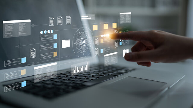 A hand engages with a laptop displaying dynamic AI data visualization, representing the convergence of technology and innovation in modern workflows. Gantry