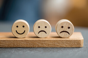 Customer service rating experience feedback emotion and satisfaction survey concept. Wooden labels with smile, normal and sad face icons, client chooses Positive Neutral or Negative pleasure score