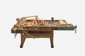 Luthier workbench with tools and violin parts isolated on white background