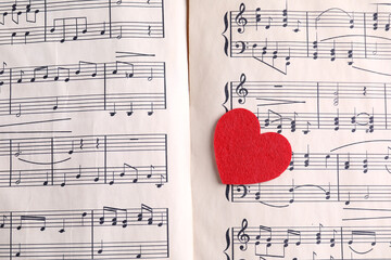 Heart figure on paper sheet with music notes, top view