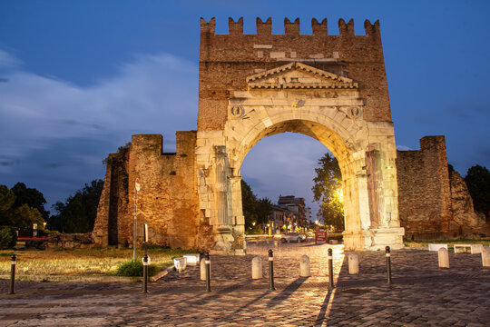 RIMINI, ITALY - JULY 2021, Roman triumphal arch at night, transformed into a medieval gate in Rimini, Italy, Emilia-Romagna