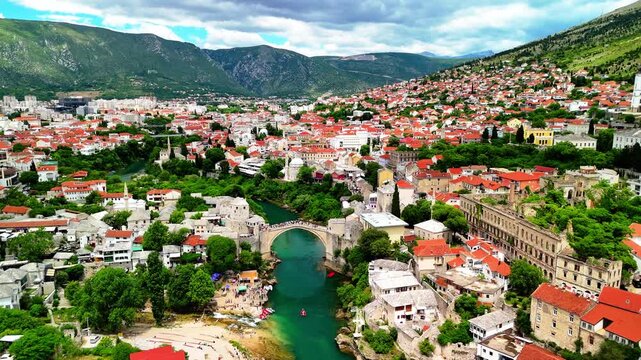 Aerial drone view of the Old Town and the Old Bridge in Mostar, Bosnia and Herzegovina. Panoramic view of the historic town and Neretva river.	
