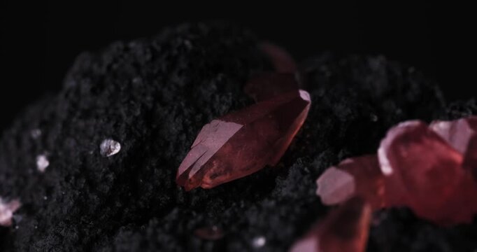 Rotating light footage of a Rhodochrosite crystal. Specimen from Uchucchacua Mine, Oy&oacute;n, Peru. macro photography detail texture background. close-up mineral crystal unpolished semi-precious gemstone
