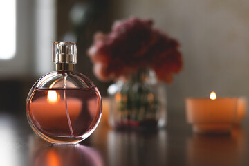 Women's perfume and lit candles. Luxurious atmosphere.