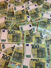 Euro banknotes background, hundred euro cash. Vertical photo