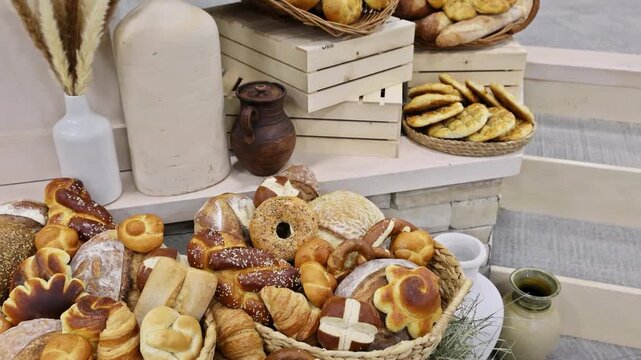 Woven basket filled with different types of freshly baked breads pastries arranged invitingly at local bakery