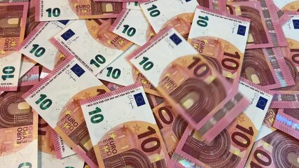 Counting euro banknotes. Pile of 10 euro bills, euro falling down, family budget and savings concept	