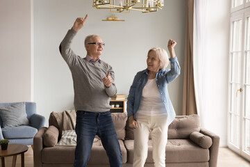 Forever young in spirit. Overjoyed elderly married couple retirees spend active leisure time at...