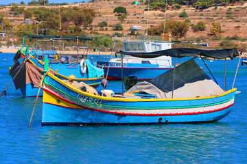 Fototapeta premium The Luzzu is an iconic Maltese fishing boat, renowned for its vibrant colours and symbolic eyes painted on the prow. Dating back to Phoenician times. MARSAXLOKK MALTA 