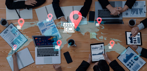 Engaging global business meeting with diverse professionals using technology and data. Focus on strategy and collaboration for impactful decisions and planning. Gantry