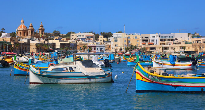 MARSAXLOKK MALTA 09 15 2024: The Luzzu is an iconic Maltese fishing boat, renowned for its vibrant colours and symbolic eyes painted on the prow. Dating back to Phoenician times