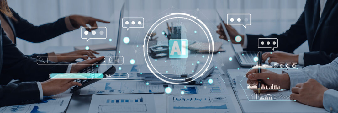 A business team collaborates on an artificial intelligence project, utilizing digital tools and engaging in discussions while analyzing data on a modern workspace. Trope - Powered by Adobe